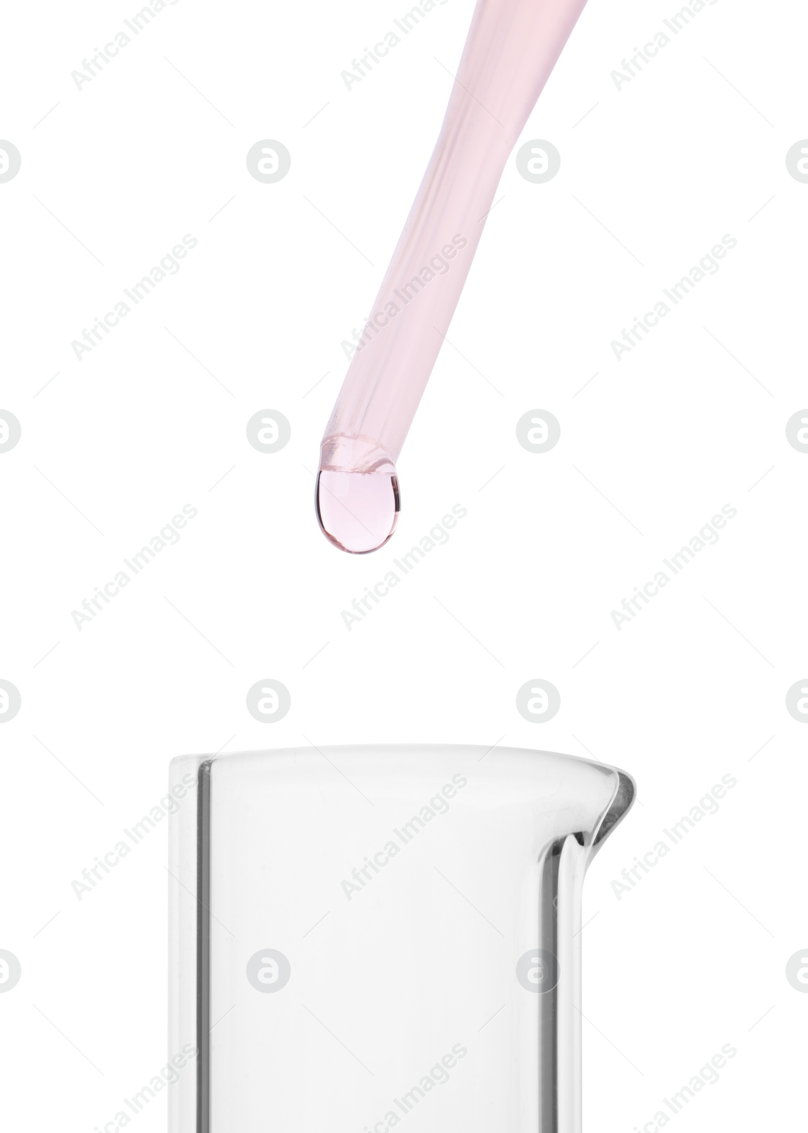 Photo of Dripping liquid from pipette into beaker on white background, closeup