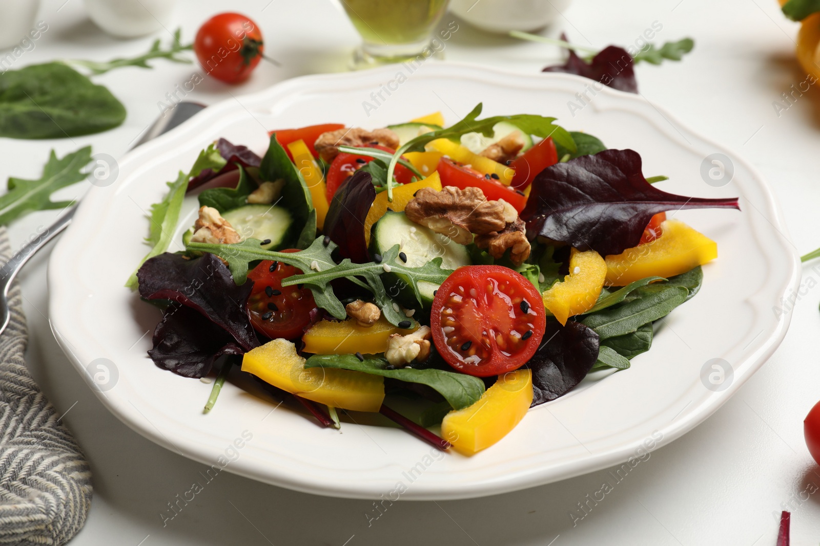 Photo of Tasty fresh vegetarian salad on white marble table, closeup