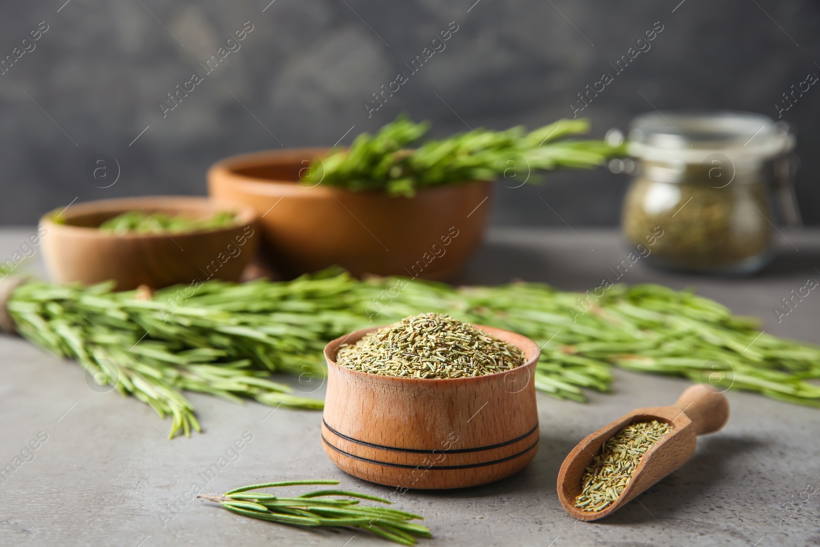 Photo of Dried rosemary and fresh twigs on grey table