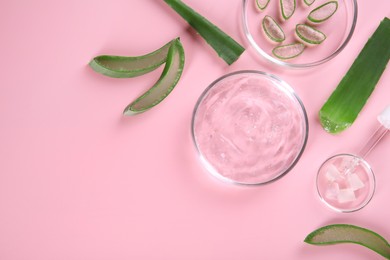 Flat lay composition with aloe vera leaves and cosmetic gel on pink background. Space for text