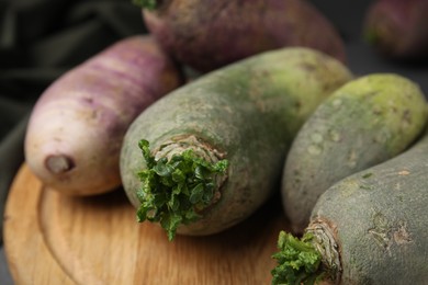 Photo of Green and purple daikon radishes on table, closeup