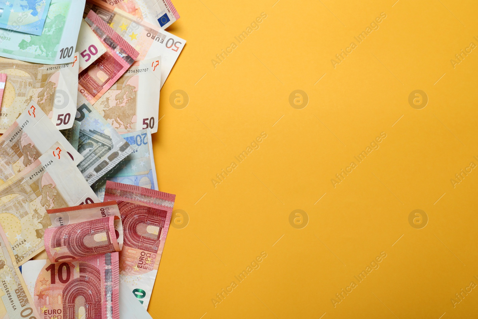 Image of Money on orange background, flat lay. Space for text 