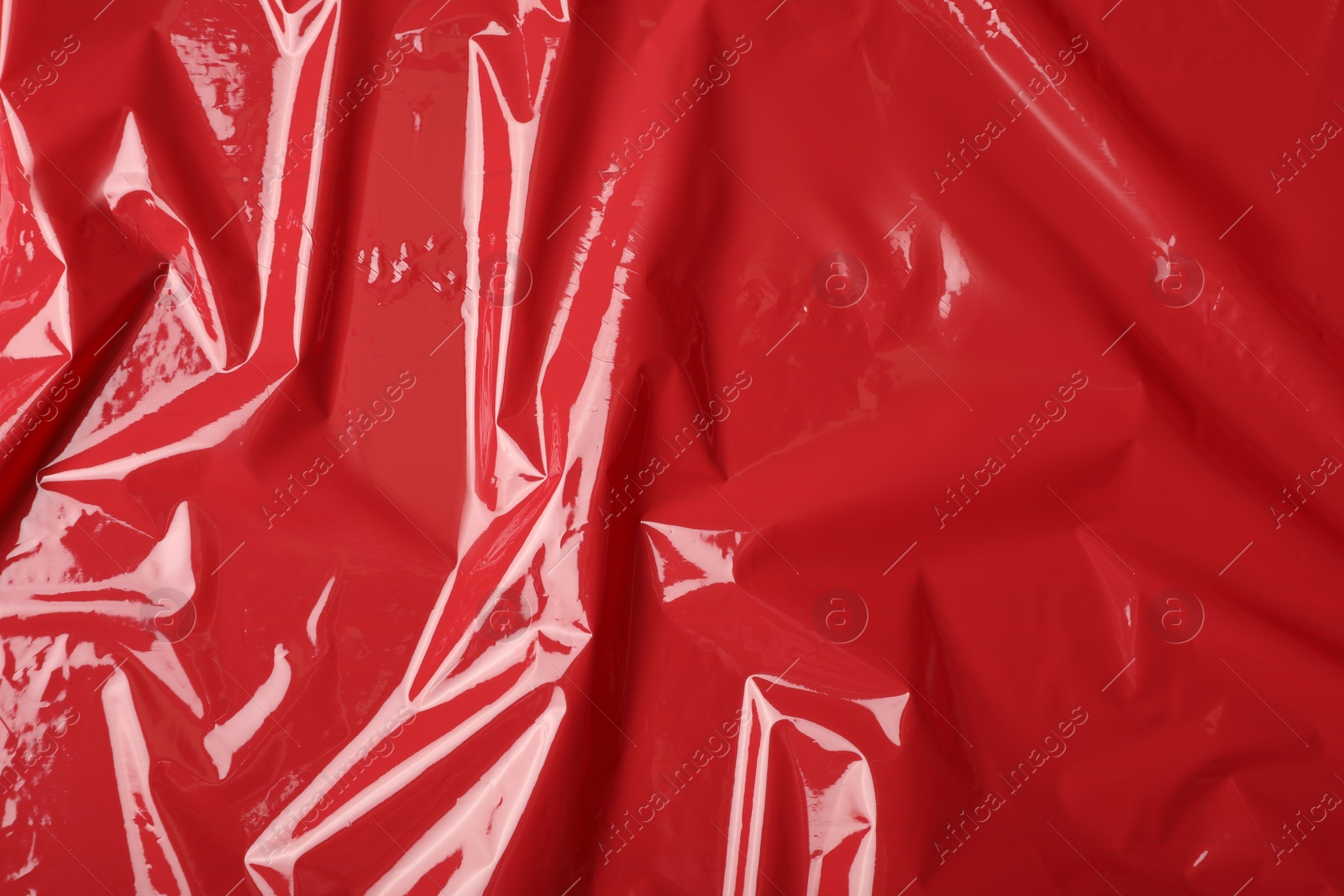 Photo of Red plastic stretch wrap as background, top view