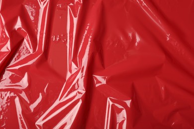 Photo of Red plastic stretch wrap as background, top view
