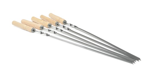 Photo of Metal skewers with wooden handle on white background