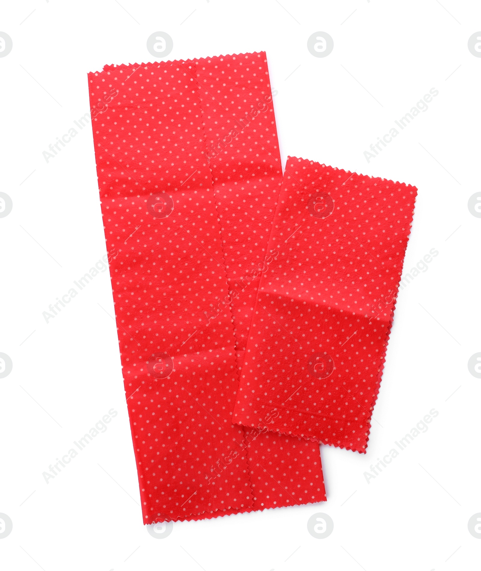 Photo of Red reusable beeswax food wraps on white background, top view