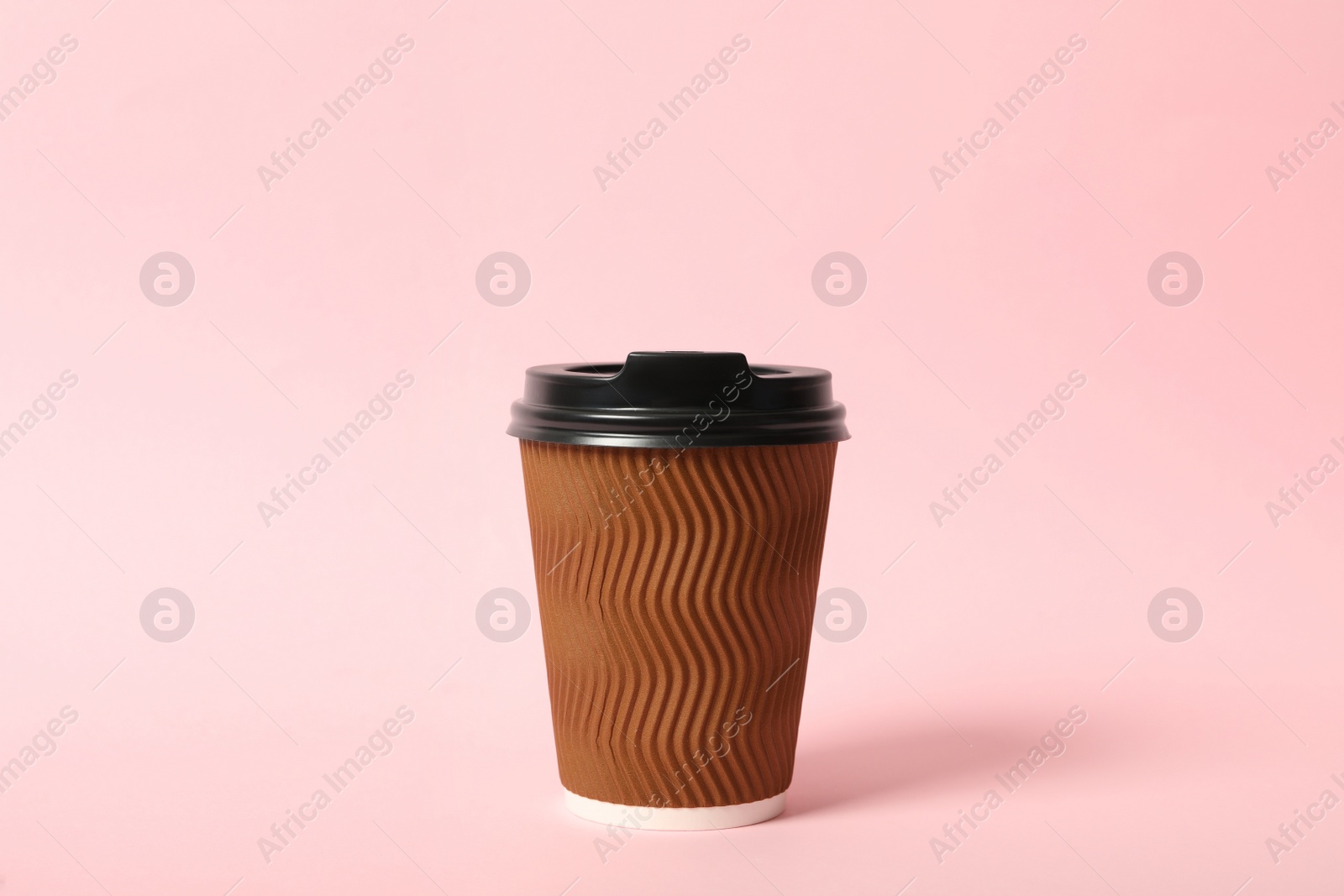 Photo of Takeaway paper coffee cup on pink background