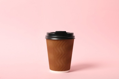 Takeaway paper coffee cup on pink background