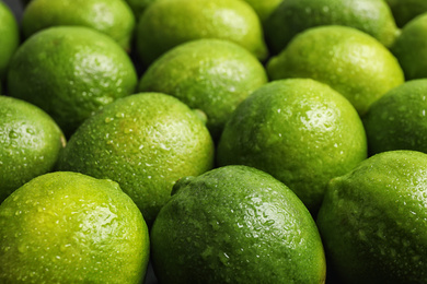 Photo of Fresh ripe juicy limes as background, closeup