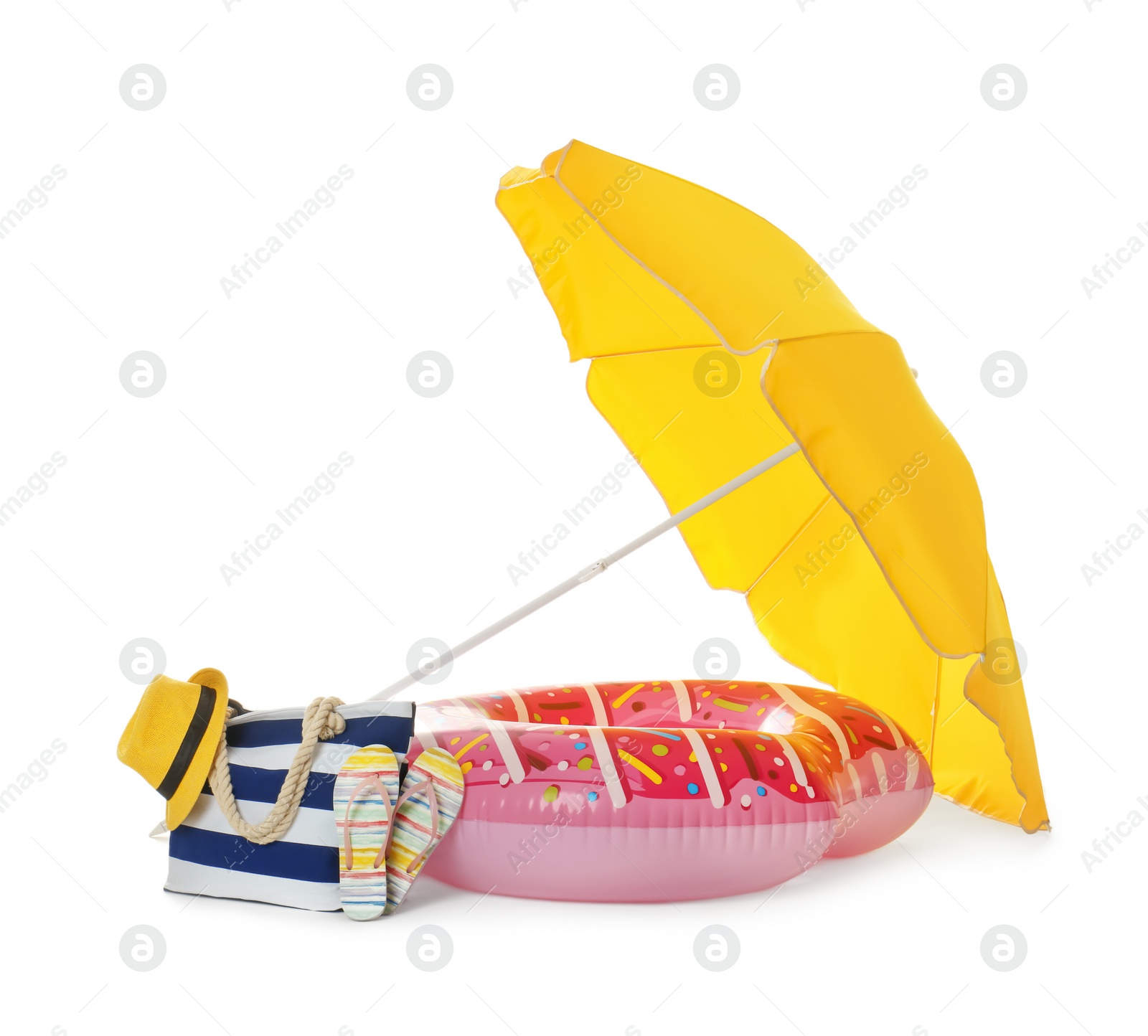 Photo of Open yellow beach umbrella, inflatable ring and accessories on white background