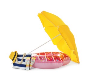 Open yellow beach umbrella, inflatable ring and accessories on white background