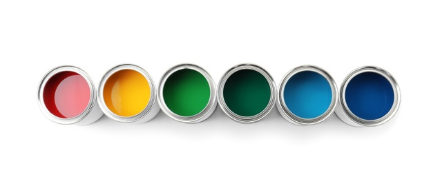 Row of paint cans on white background, top view