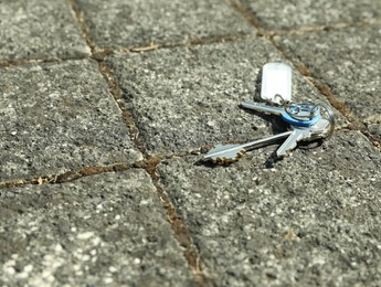 Photo of Bunch of lost keys on pavement outdoors, space for text