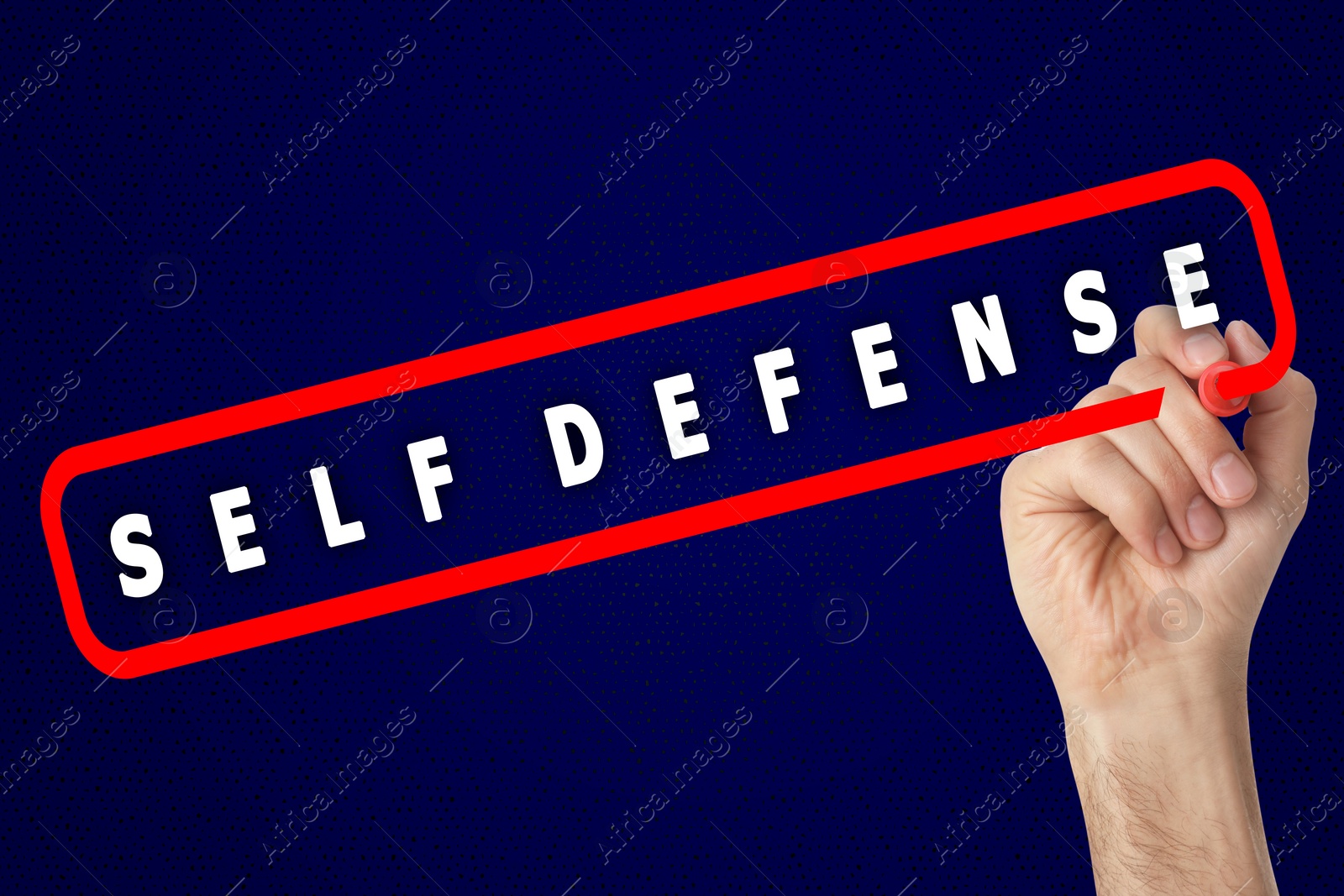 Image of Man contouring words Self Defense with marker glass board against blue background, closeup