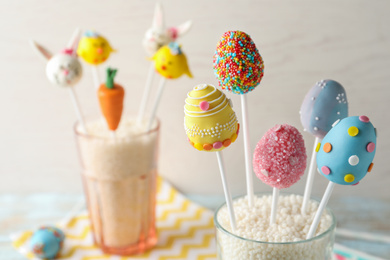 Photo of Egg shaped cake pops on light background, space for text. Easter celebration