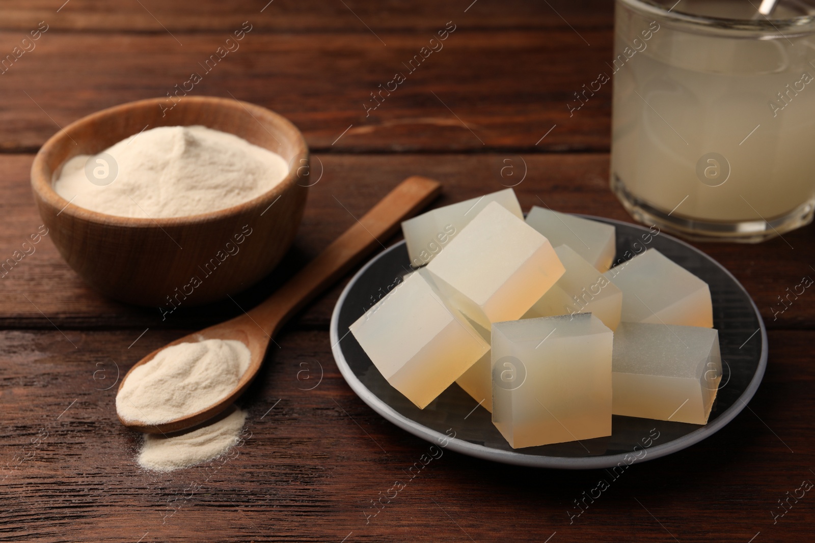 Photo of Agar-agar jelly and powder on wooden table