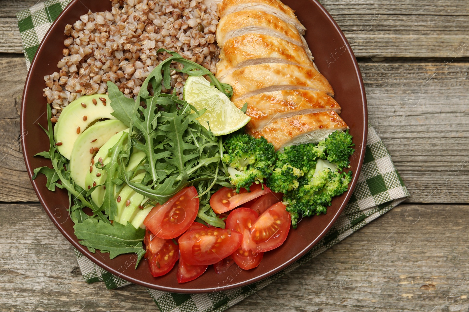 Photo of Healthy meal. Tasty products in bowl on wooden table, top view