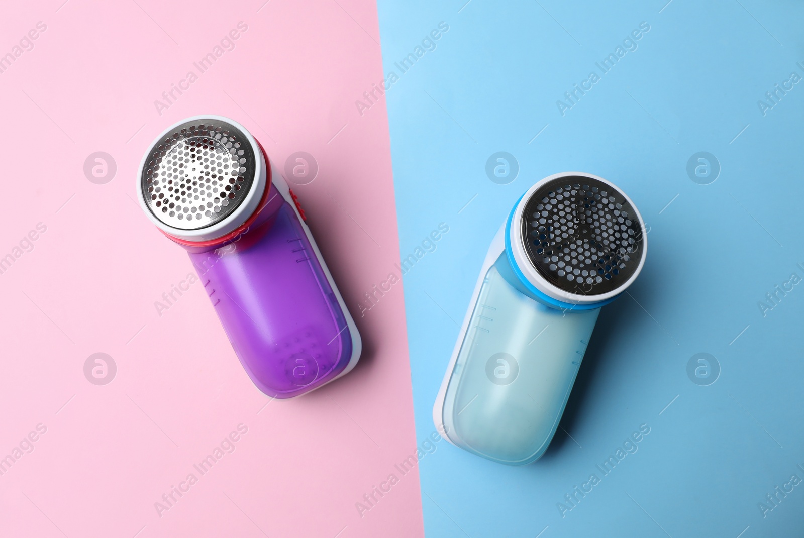 Photo of Modern fabric shavers on color background, flat lay