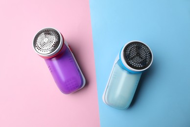 Photo of Modern fabric shavers on color background, flat lay