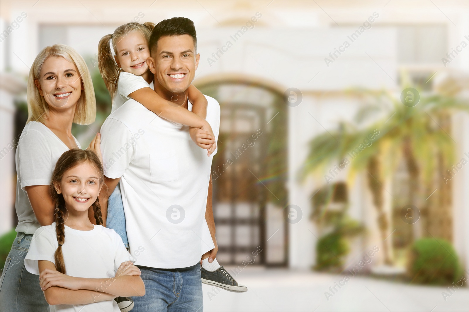 Image of Dream home. Happy family near big beautiful house. Space for text