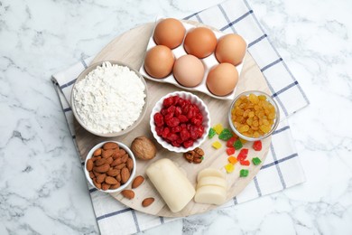 Photo of Marzipan and other ingredients for homemade Stollen on white marble table, top view. Baking traditional German Christmas bread