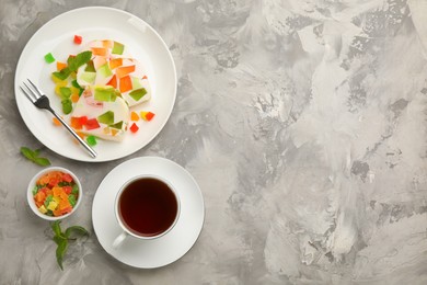 Delicious broken glass jelly dessert on white marble table, flat lay. Space for text