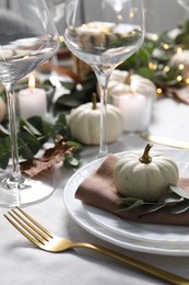 Beautiful autumn table setting, pumpkin and eucalyptus branch