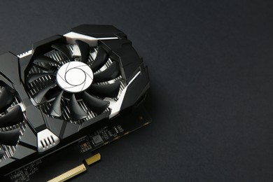Photo of Computer graphics card on black background, closeup. Space for text