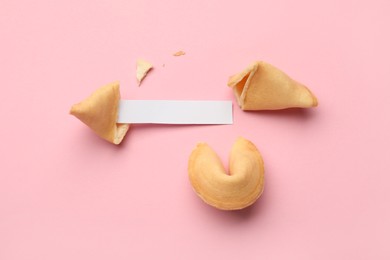 Tasty fortune cookies with predictions on pink background. Space for text