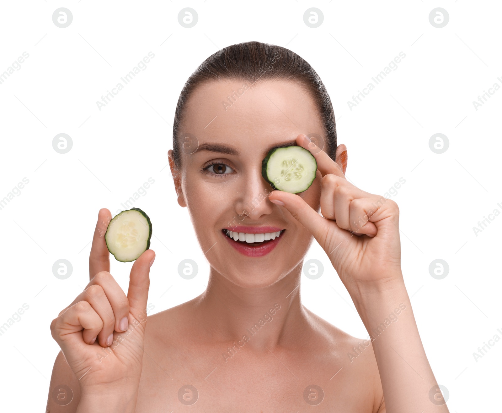 Photo of Beautiful woman covering eye with piece of cucumber on white background