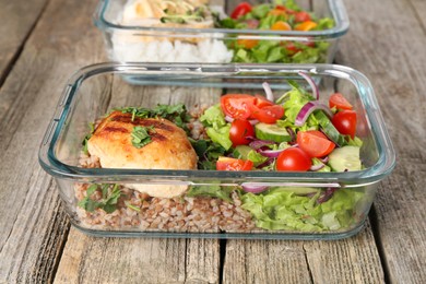 Photo of Healthy meal. Containers with different products on wooden table, closeup