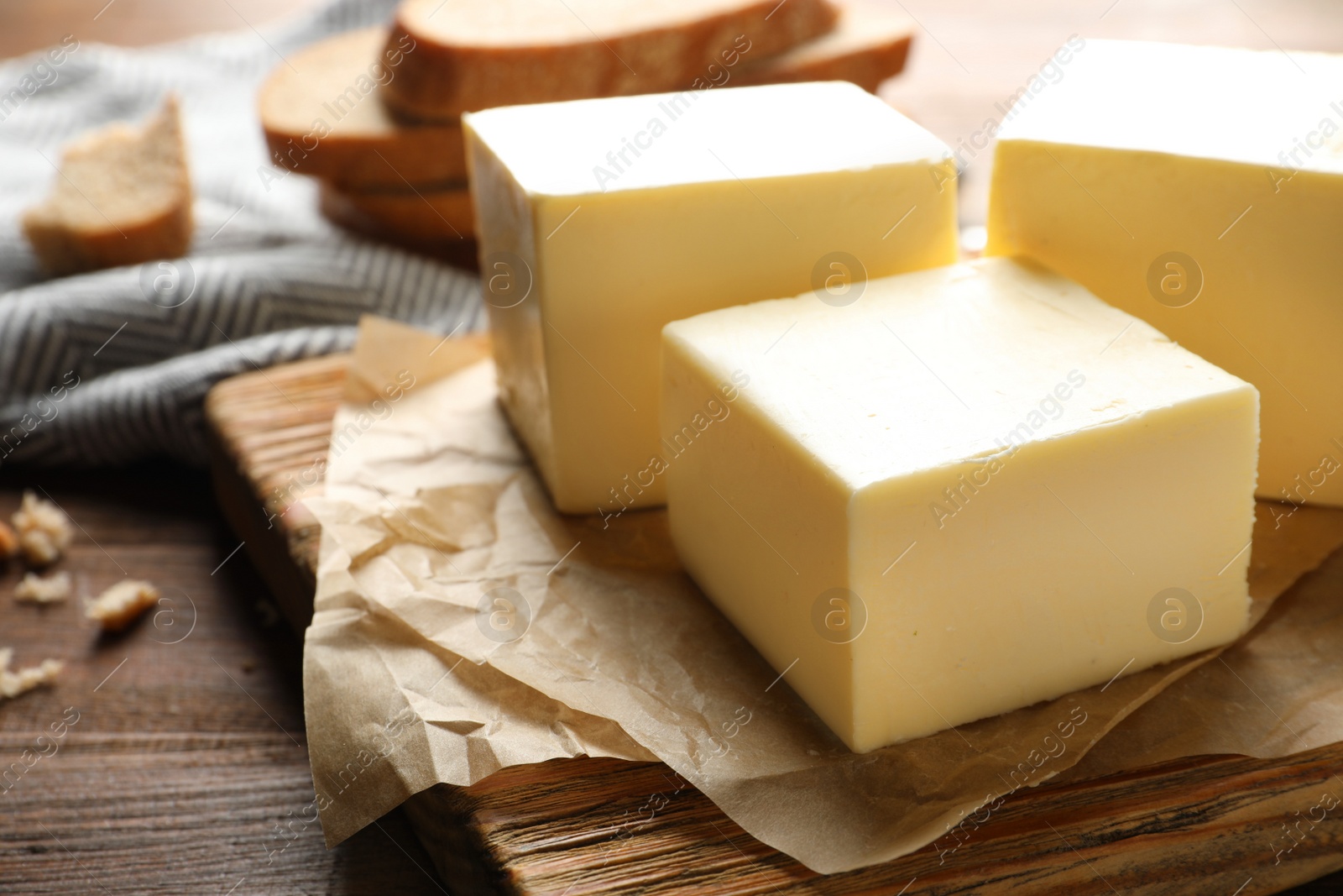 Photo of Wooden board with fresh butter on table, closeup