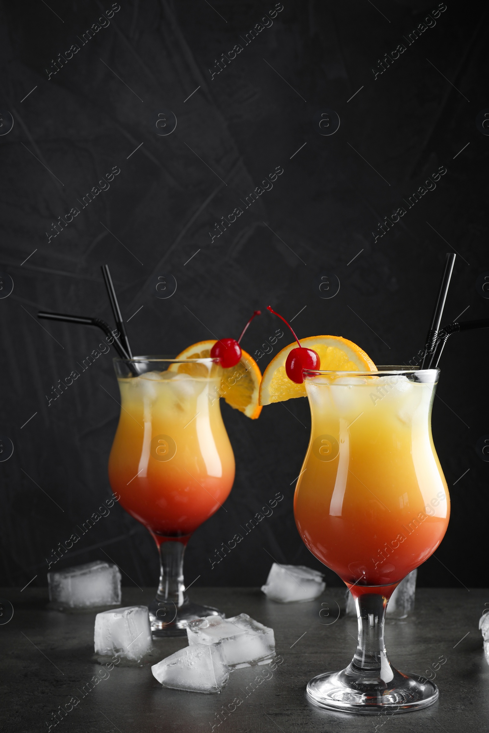 Photo of Just made appetizing cocktails Sex on the Beach, black background