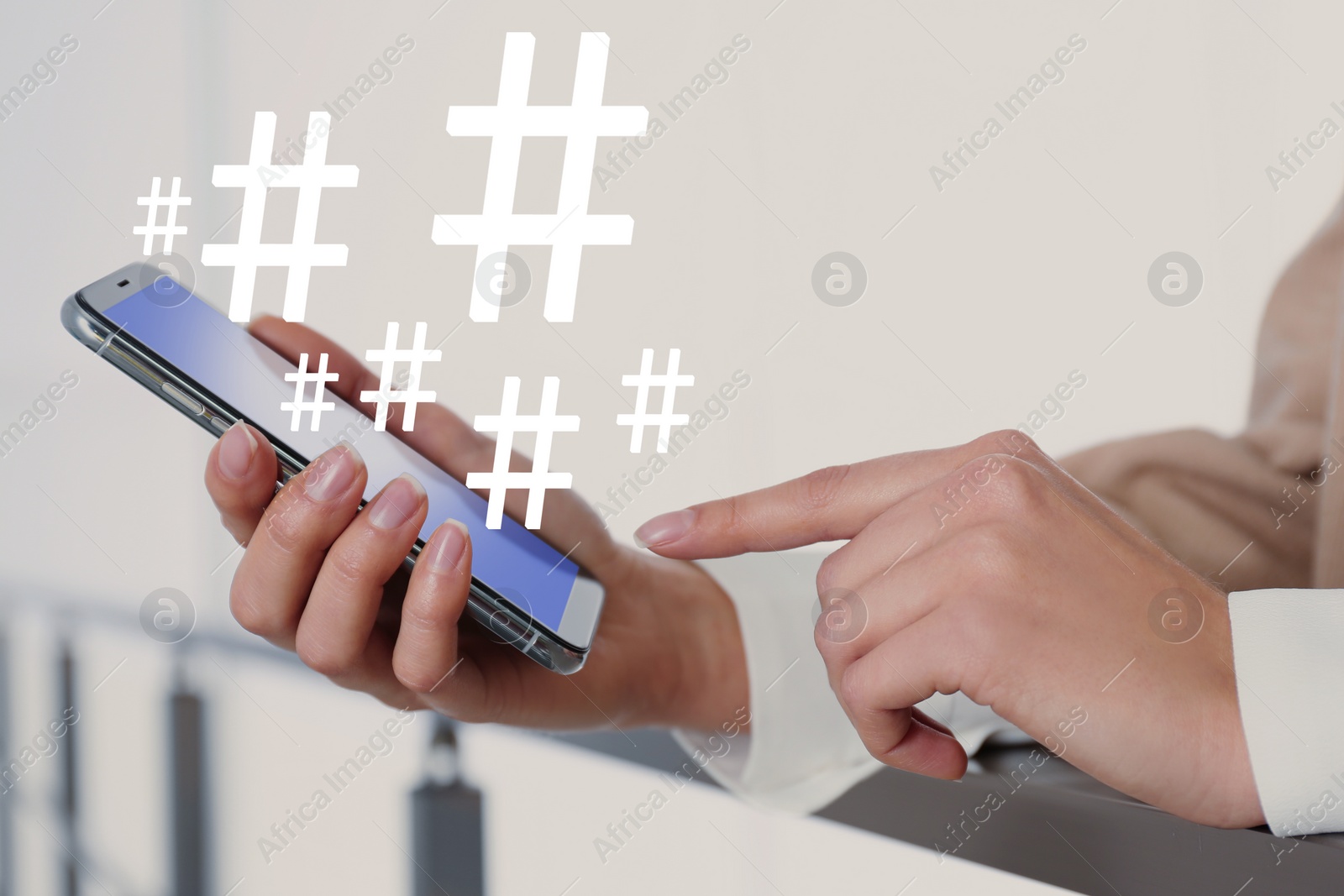 Image of Woman using modern smartphone, closeup. Hashtag symbols over device