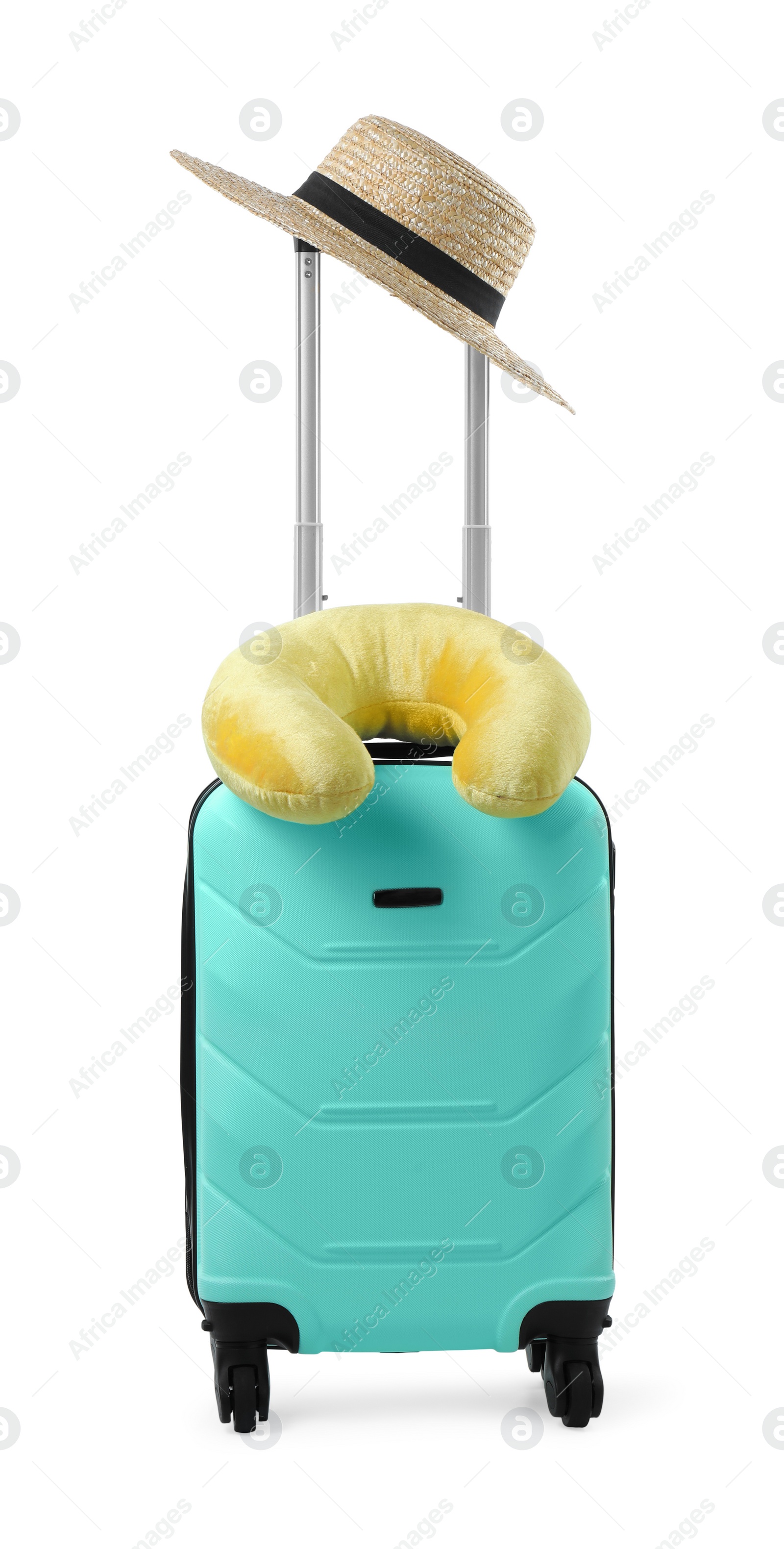 Photo of Soft travel pillow and hat on turquoise suitcase isolated on white