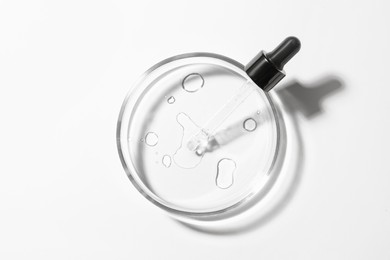 Petri dish with pipette on white background, top view