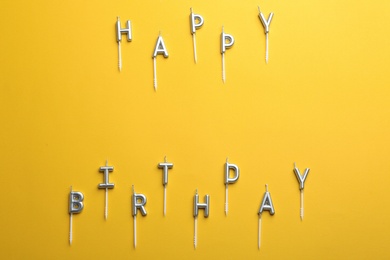 Flat lay composition with birthday candles on color background. Space for text
