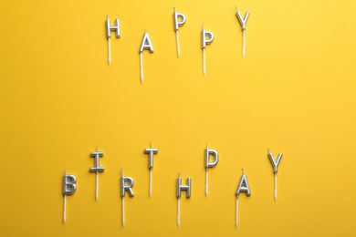 Photo of Flat lay composition with birthday candles on color background. Space for text