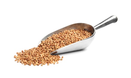 Photo of Scoop with uncooked buckwheat on white background