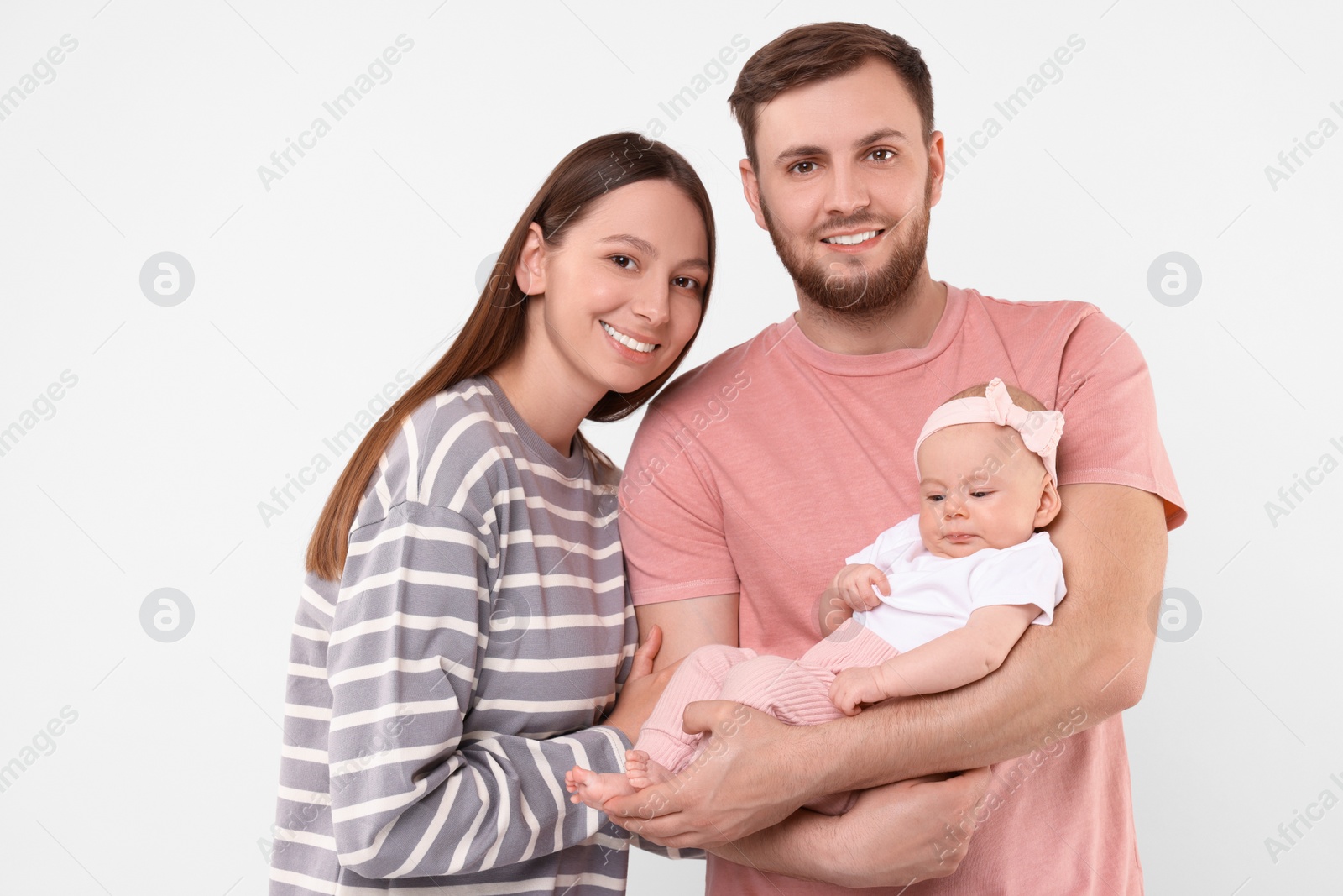 Photo of Happy family. Parents with their cute baby on light background