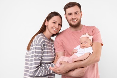 Photo of Happy family. Parents with their cute baby on light background