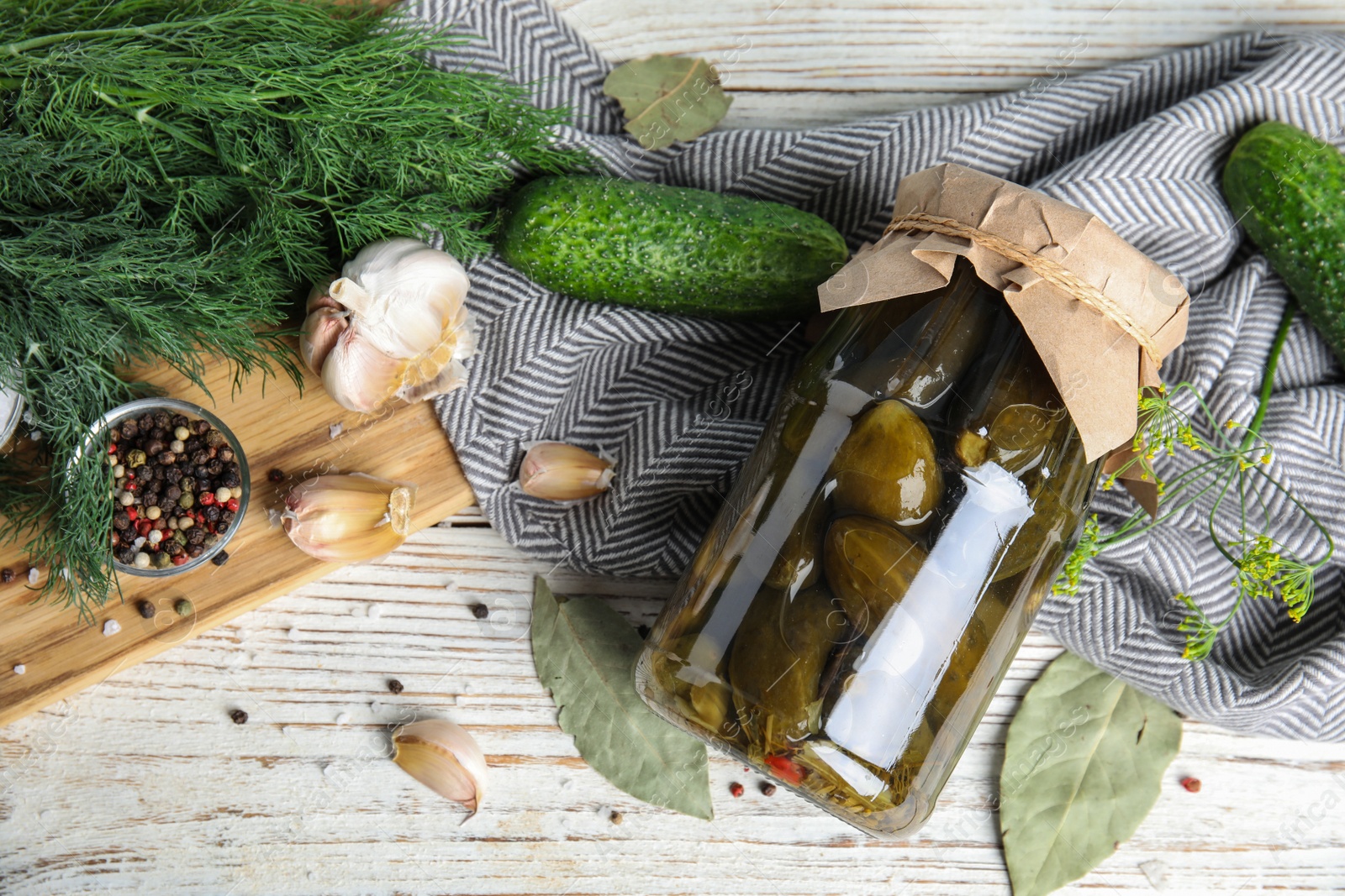 Photo of Flat lay composition with jar of pickled cucumbers on white wooden table