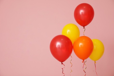 Bright balloons on color background, space for text. Celebration time