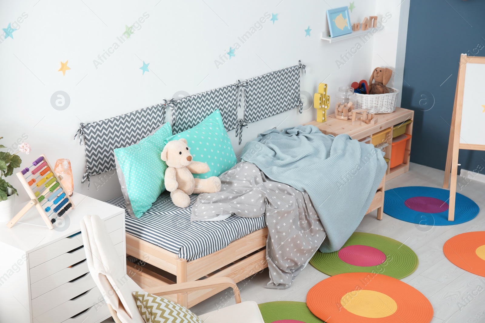 Photo of Modern child room interior with comfortable bed and armchair