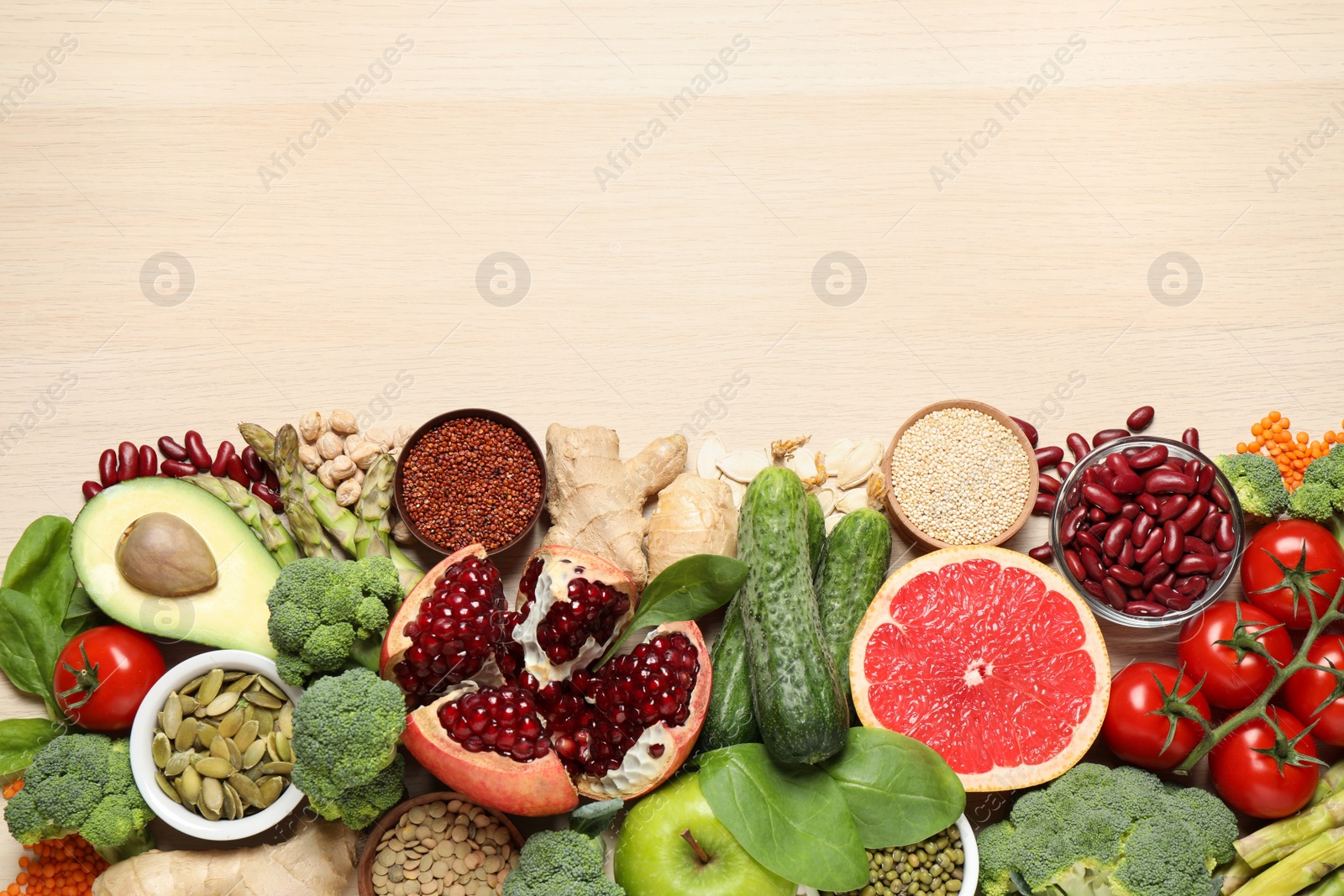 Photo of Fresh vegetables, fruits and seeds on light table, flat lay. Space for text.