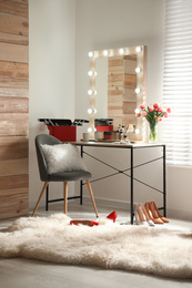 Photo of Dressing table and mirror with lamps in stylish room interior