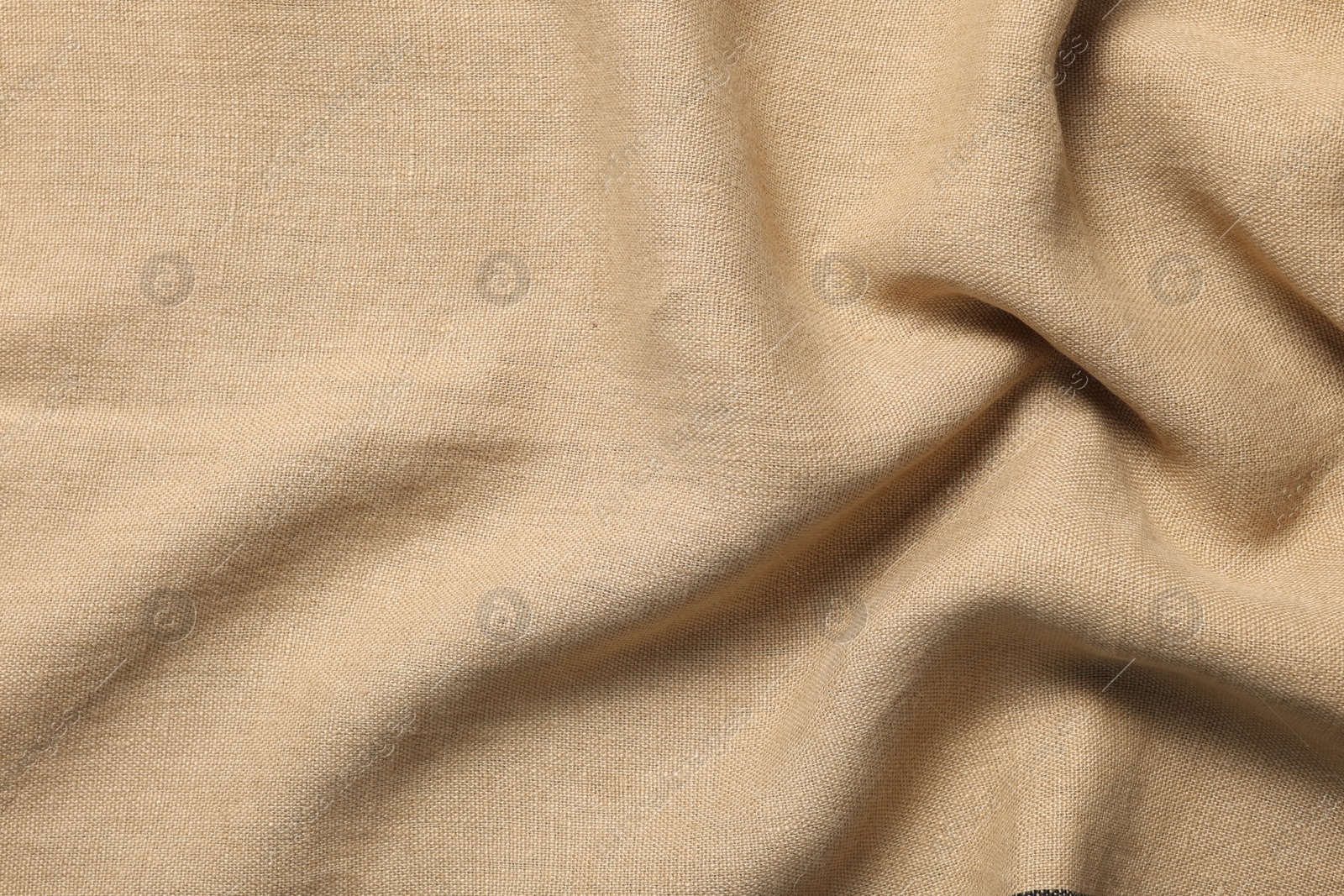 Photo of Texture of beige crumpled fabric as background, top view