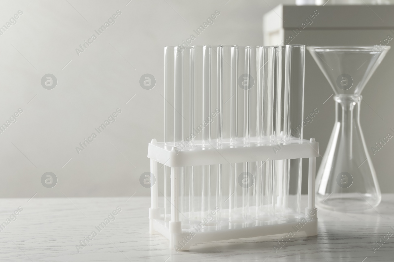 Photo of Set of laboratory glassware on white wooden table indoors, space for text
