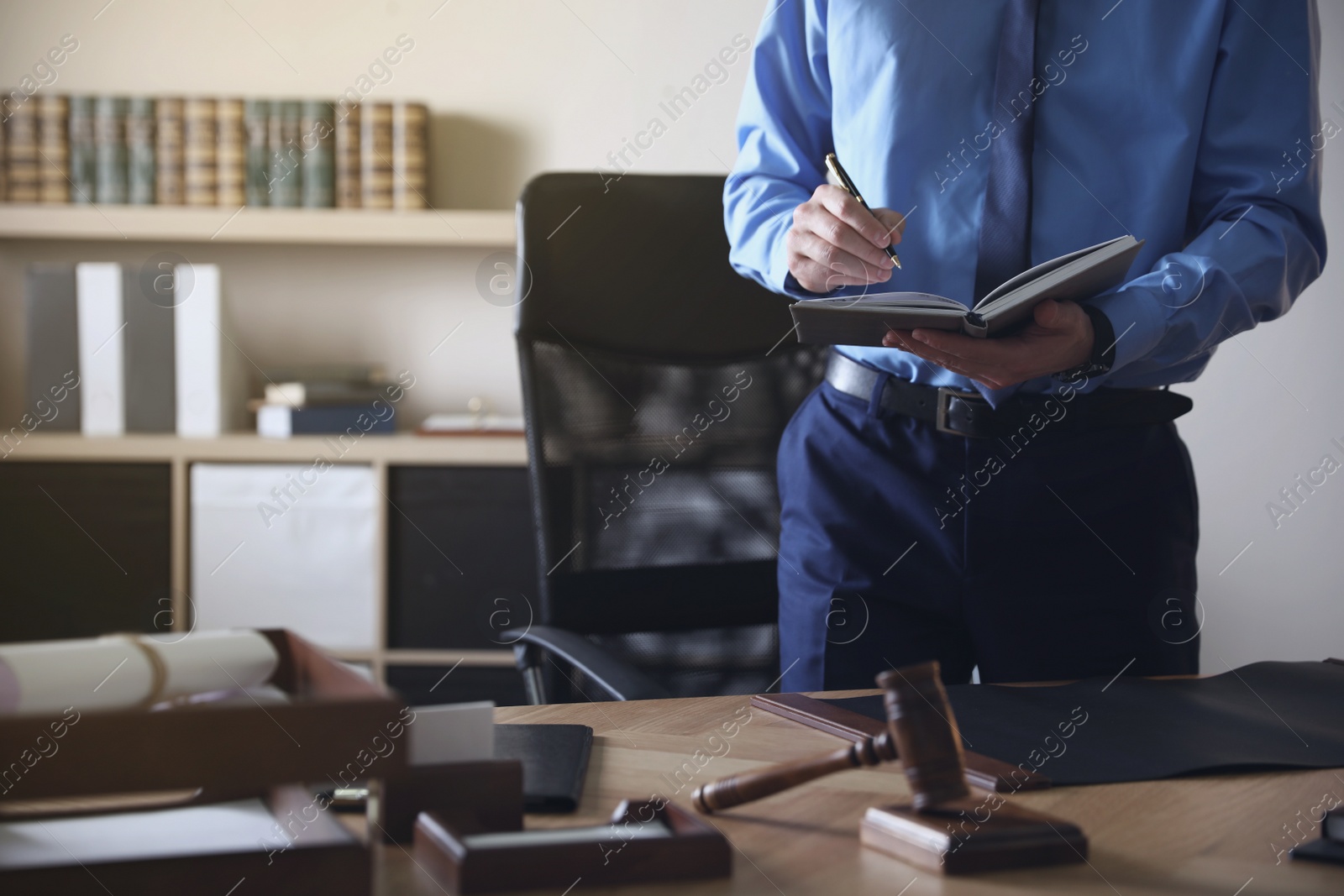 Photo of Male lawyer working at table in office, closeup