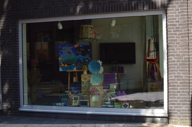 Photo of AMSTERDAM, NETHERLANDS - JULY 16, 2022: Showcase of Philadelphia shop, view from outdoors